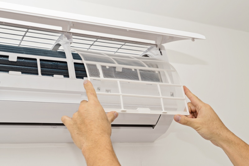 What Maintenance Is Needed for a Ductless System? Changing the filter in the air conditioner. The concept of safe and healthy housing.